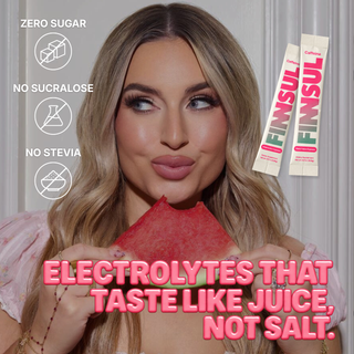 A woman holds a pink electrolyte powder pouch in front of her face, with two FINSUL stick packs shown on the right. Text on the image highlights zero sugar, no sucralose, no stevia, and electrolytes that taste like juice, not salt.